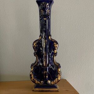 A vintage cobalt blue porcelain cello-shaped decorative vase with gold trim.